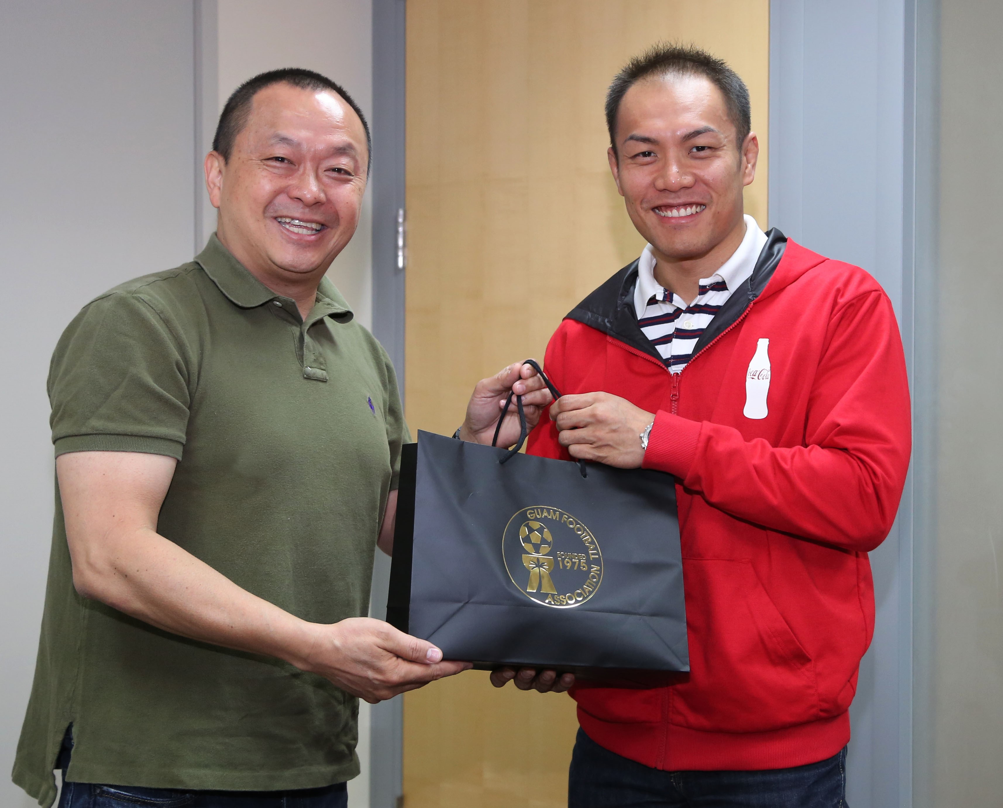 (Friday, February 27, 2015; Barrigada Heights, Guam) In the photo is Guam Football Association President Richard Lai (left) presenting a gift from GFA to Marcos Fong, CEO of Foremost Foods, Inc. & Coca-Cola Beverage Company (Guam) after signing a two-year partnership.