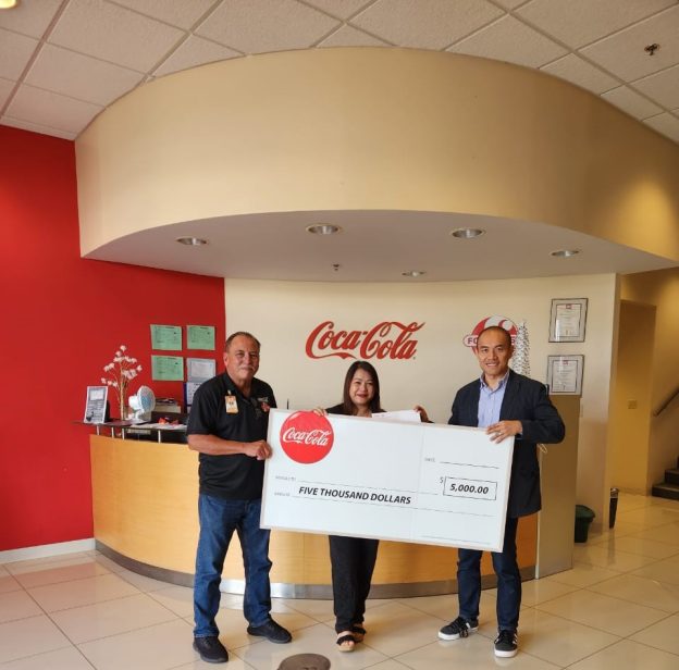 <b>GRAND PRIZE WINNER.<b/> Luzviminda C. Cortado, grand prize winner of the “Magic of Christmas $12,000 Cash Giveaway” holiday promo, receives $5,000 in cash from CEO Marcos W. Fong (right) and Sales Manager Jose Fernandez, both of Coca-Cola Beverage Co. (Guam), Inc., on Jan. 19, 2024 at the Coca-Cola corporate headquarters in Barrigada Heights.